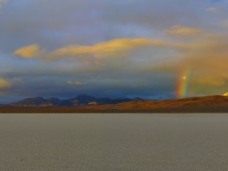 panorama view of rainbow over the Racetrack Death Valley National Park