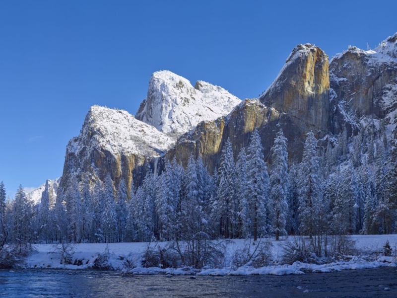 the Cathedral Rocks and Leaning Tower in winter snow Yosemite National Park