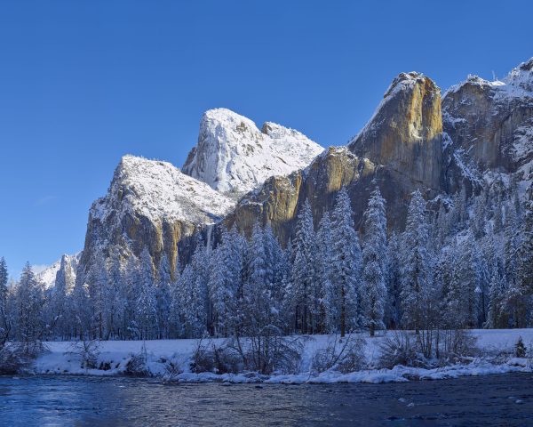 the Cathedral Rocks and Leaning Tower in winter snow Yosemite National Park
